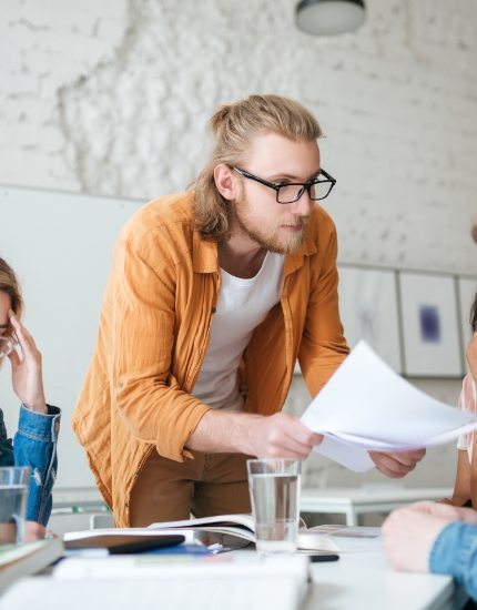 group-of-upset-students-sitting-at-the-table-with-E5YW9L4-1.jpg